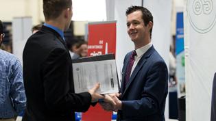 Employer talks with student during career fair